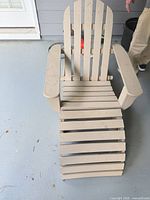 Beige composite Adirondack chair with extended footrest