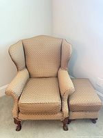Front and side view of wingback armchair with ottoman