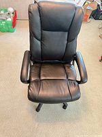 Front view of black faux leather office chair showing overall design