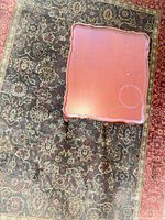 Top view showing cherry veneer surface, scalloped edges, water ring and scratches