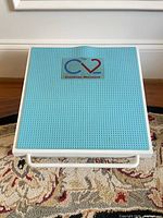 Top view showing teal perforated surface and CV2 logo