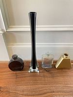 Group shot of four glass bud vases in various shapes and colors