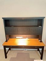 Front view showing desk, oak top, hutch with drawers, power strip