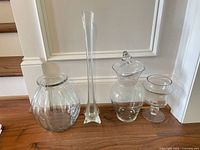 All four clear glass pieces lined up on floor