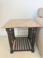 Full view of marble top end table beside sofa
