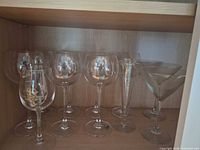 All ten clear stemware pieces grouped on shelf