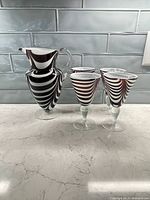 Group view of pitcher with four matching swirl glasses