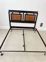 Overall view of partially assembled queen bed frame with attached headboard