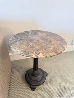 Overall view of side table showing faux marble top and metal base