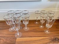 All 17 Lenox silver-rim crystal stemmed glasses grouped on wooden surface