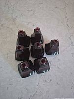 Top view showing all 8 purple glass perfume bottles without stoppers