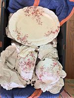 Large platter with red floral pattern; covered dish base and lid below
