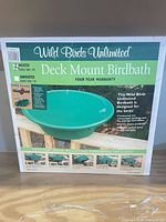 Front of retail box showing Wild Birds Unlimited Deck Mount Birdbath model WBU 13B