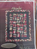 Front of sealed kit showing Akimbo pattern cover