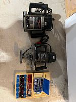 Two Black & Decker routers, wood box with bits and adapter
