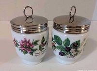 Front view of two Royal Worcester jumbo egg coddlers showing Wild Thyme and Blackberry patterns with stainless lids