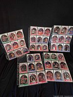Four binder pages holding NBA Hoops cards in sleeves