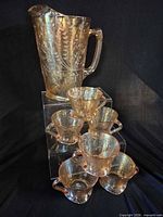 Full view of pitcher and stacked cups showing overall set