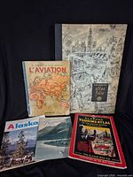 Group shot of all five printed items front covers visible