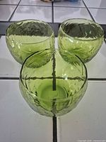 Three avocado green textured glass cups top view