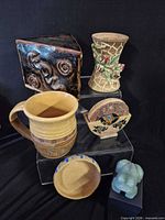 Group shot showing mug, vase, stone coasters in holder, carved jade frog