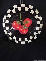 Front view of platter showing tomato motif and checkerboard rim