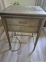 Closed cabinet front showing drawers and legs