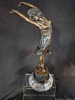 Full view of bronze dancer on marble base