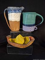 Group photo showing pitcher, mug and citrus juicer