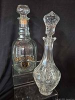 Both decanters side-by-side showing overall form and stoppers