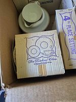 Island Gold pattern boxed place setting in carton