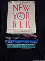 Front cover of New Yorker book atop stack showing titles of all six books