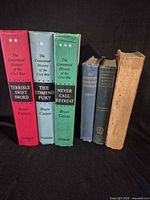 Spines of all six books showing titles and wear