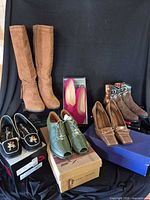 Group shot showing all visible pairs of shoes and boxes