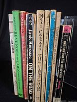 Spine view of all nine paperback books showing titles and wear