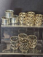 Group shot of all eleven napkin rings on clear riser