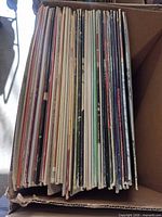 Box of LPs showing spines of multiple records