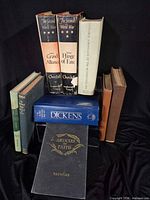 Group shot of all nine hardcovers standing and stacked