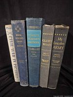 Spine view of all five books showing titles and authors