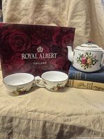 Teapot, two teacups and Royal Albert box displayed
