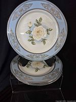 Two plates on stand showing full design and border