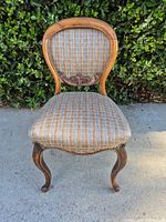full front view of chair showing frame, upholstery, legs