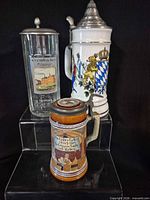 All three steins front view on clear riser