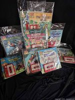 Front view showing eight of the sealed read-along book & cassette sets