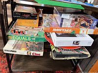 Stack of all board games and puzzles on shelf