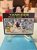 Front view showing team name, player name, trophy icon, printed signature, overall surface and corner condition
