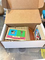 Open storage box showing rows of vintage Topps cards