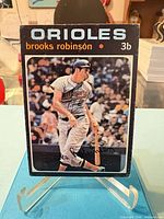 Front of 1971 Topps Brooks Robinson #300 baseball card on stand, showing image, borders and condition