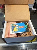 Open box showing large stack of 1980s Topps baseball cards.