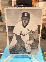 Front view of signed Bob Gibson postcard on stand